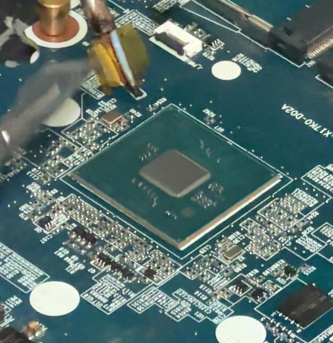 Component-level work on a board, under hot air.